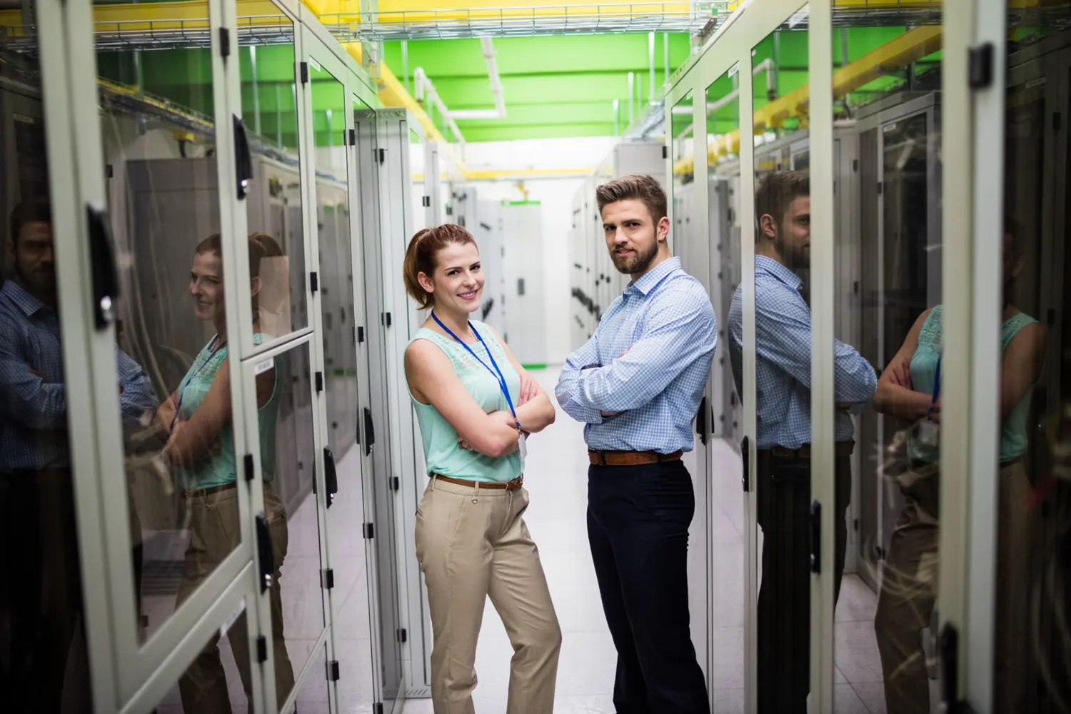 IT professionals standing in a server room supporting network infrastructure